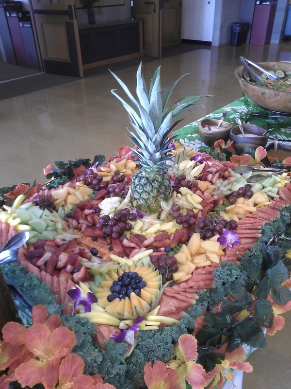 Large fruit platter carved into a diamond pattern with a whole pineapple centerpiece